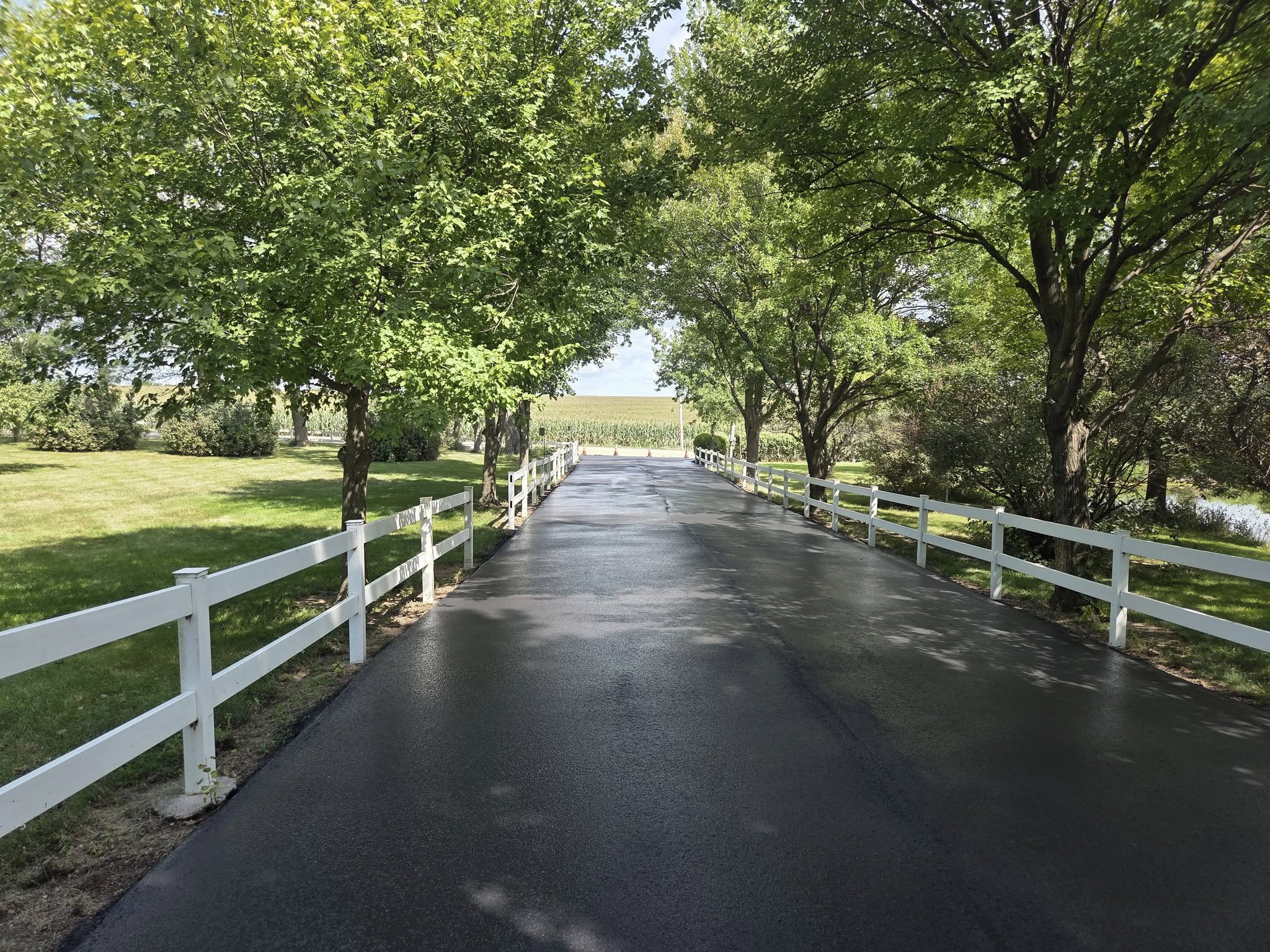 Professional sealcoating on a driveway